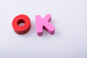 The word OK written with colorful letter blocks