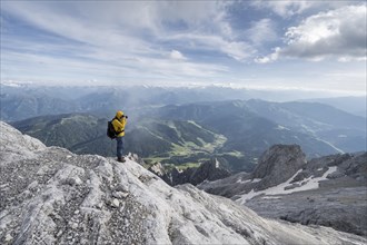 Mountaineer at the summit of the Hochkoenig