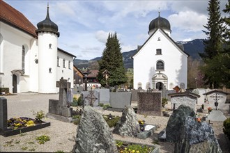 Cemetery in Fischen im Allgaeu with St. Verena Church and Lady's Chapel
