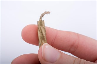 Gold colorl candle stick in hand on a white background
