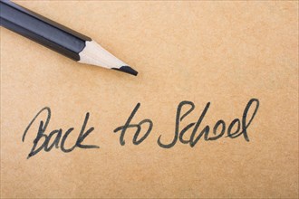 Black Color pencil and back to school title on a notebook