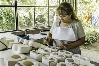 Ceramist with her hands dirty with clay