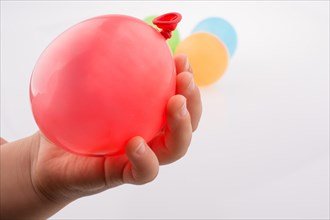 Hand holding a Colorful small balloon