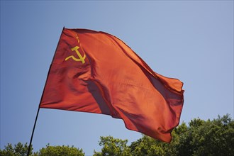 Russian national flag with hammer and sickle waving in the wind