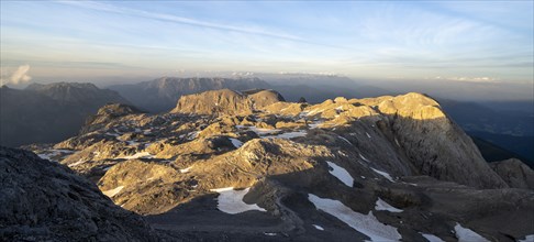View of rocky plateau with remnants of snow in the evening light