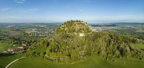 Aerial panorama of the volcanic cone Hohentwiel with the castle ruins illuminated by the evening sun