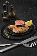 Fried tuna steak on a stone plate