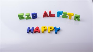 The word EID EL FITR written with colorful letter blocks