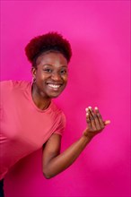Young african american woman isolated on a pink background inviting to come with her hand