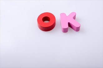 The word OK written with colorful letter blocks
