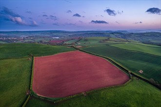 Sunset over fields and farms from a drone