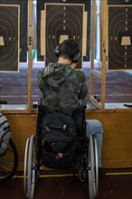 Man in Wheelchair Shooting with a Gun on Shooting Range with Target in Switzerland