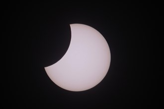 Solar eclipse partial umbra against black sky