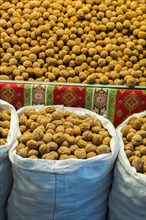 Sack of whole fresh walnuts with hard nutshells