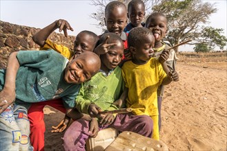 A group of African children with self-made drums singing and playing
