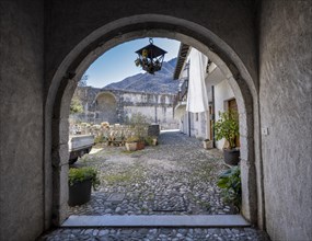 View through an archway into a courtyard