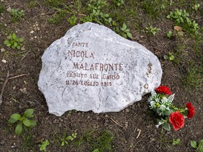 Memorial stone with flowers in the Parco della Rimembranza