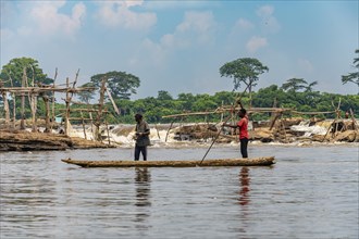 Fishermen in their dugout canoe