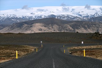 Road to the small peninsula of Dyrholaey on the south coast with a view of the glacier Myrdalsjoekull