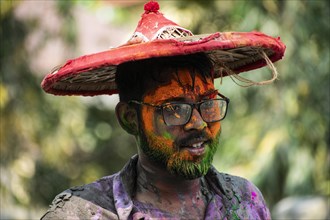 Reveller smear with 'Gulal' or coloured powder to celebrate Holi