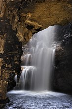 Waterfall created by the Smoo burn dropping into the Smoo cave through a sinkhole near Durness in the Highlands