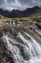 Waterfall of the Fairy Pools in front of the Black Cuillin in Glen Brittle on the Isle of Skye