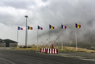 Six flags at the border crossing from Andorra to France