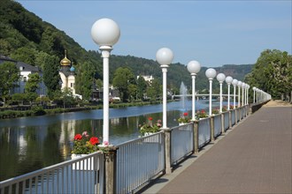 Lahn riverside promenade with row of street lamps and view of Russian church St. Andreas