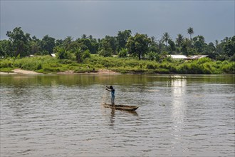 Fisherman in his dugout canoe