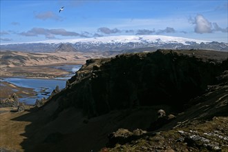 Small peninsula Dyrholaey on the south coast with view of the glacier Myrdalsjoekull