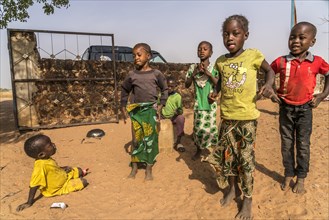 A group of African children singing and playing