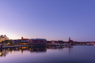 Town harbour of the small town of Waren in the evening light