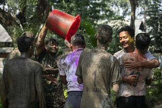 Revellers palying mud to celebrate Holi