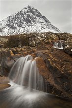 Scottish mountain Buachaille Etive Mor and waterfall on River Coupall in winter in Glen Etive near Glencoe in the Highlands of Scotland