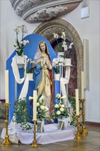 Statue of the Virgin Mary with candles