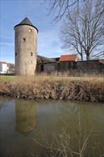 Historic mill tower by the stream and town wall