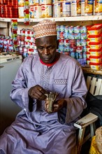 Local money changer in the Market in Dalaba