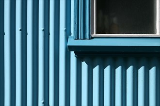 Detail of blue corrugated iron house cladding