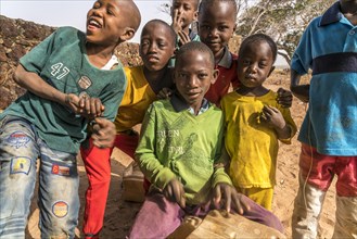 A group of African children with self-made drums singing and playing