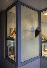 Burglary jeweller's window broken with hammer