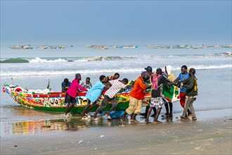 Men pulling Colourful fishing boat