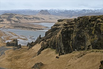 Small peninsula Dyrholaey on the south coast with view of the glacier Myrdalsjoekull