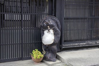 House front raccoon dog ornament at Narai-juku traditional small town in Nagano Japan
