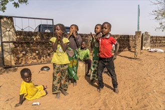 A group of African children singing and playing