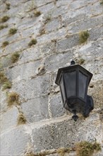 Street lamp on a stone wall in Bybloss Lebanon Middle East