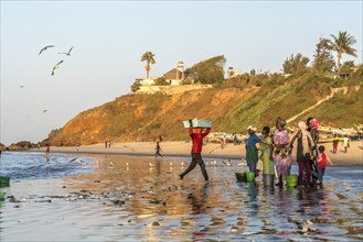 Fishermen's wives on the beach at the fish market