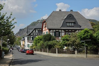 Half-timbered houses in Frankenweg and view of Drachenfels Castle