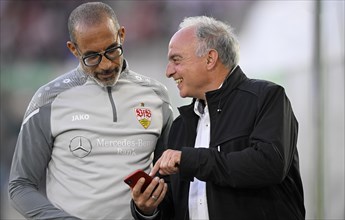 Former international Hans Hansi Mueller VfB Stuttgart shows club doctor Dr Raymond Best VfB Stuttgart something on smartphone