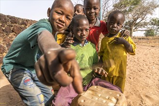 A group of African children with self-made drums singing and playing