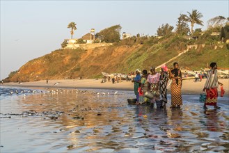 Fishermen's wives on the beach at the fish market